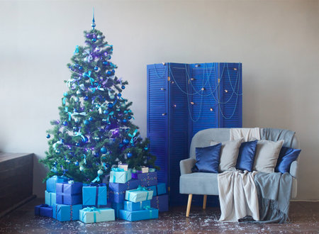 Room decorated for Christmas or new year. The interior of the room with a Christmas tree and decorations for the holiday.の写真素材