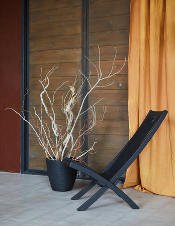 A black chair in the loft style interior. Plants decorate the room.の写真素材
