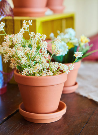 Artificial flowers in a vase. Decor for a children's or bright room.の写真素材