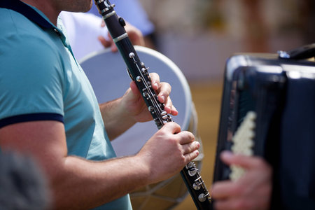 Musical instrument clarinet in the hands of a male musician. The concept of culture and art.の写真素材