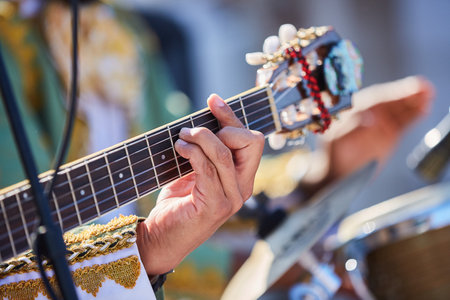 Stringed musical instrument acoustic guitar in the hands of a male musician. The concept of culture...
