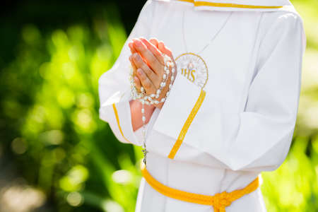 First Holy Communion. A child holding a rosaryの写真素材
