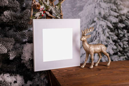 White picture frame with decorations. Mock up for your photo or text. Place your work, print art, white background, pastel color book. Photo realistic 3d illustration. Minimalist Christmas interior decoration. reindeerの写真素材