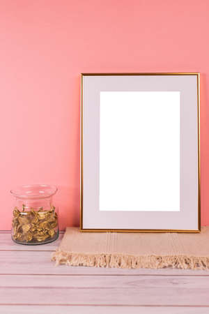 Gold picture frame with decorations. Mock up for your photo or text. Place your work, print art, white background, pastel color book. Photo realistic 3d illustrationの写真素材