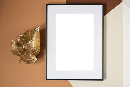 Black picture frame with decorations. Mock up for your photo or text. Place your work, print art, white background. Photo realistic 3d illustration. Brown backgroundの写真素材