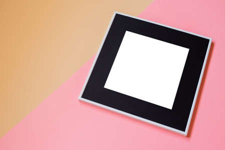 White picture frame with decorations. Mock up for your photo or text. Place your work, print art, white background, pastel color book. Photo realistic 3d illustration. Pink and orange backgroundの写真素材