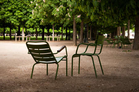 Two green emty chairs standing in a parkの写真素材