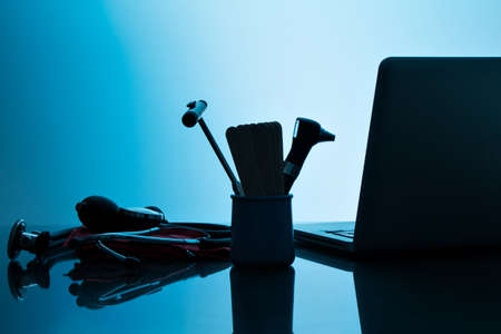 Medical office desk, with computer and medical instrumentsの写真素材