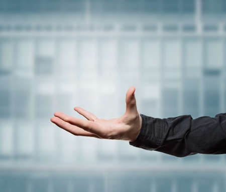 Businessman with shirt holding a virtual symbol in his handの写真素材