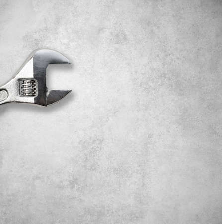 Wrench in front of a gray concrete wallの写真素材