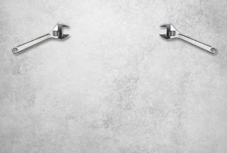 Wrench holds lettering customer service in front of a gray concrete wallの写真素材