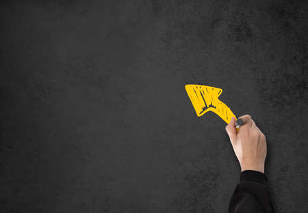 Business Man writing something on a gray wallの写真素材