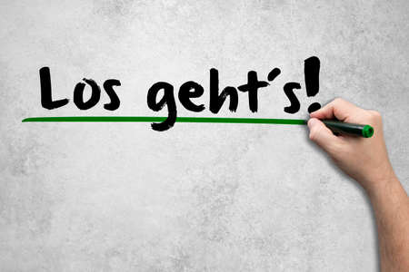 Man writes a concept to the concrete wall. Here we go!の写真素材