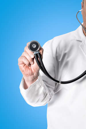 Doctor in white coat holding a stethoscope in his handの写真素材