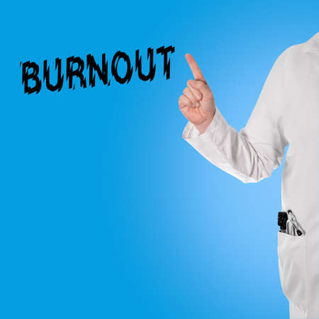 Doctor pointing at the word burnout, and in the pocket is a stethoscope and ophthalmoscopeの写真素材
