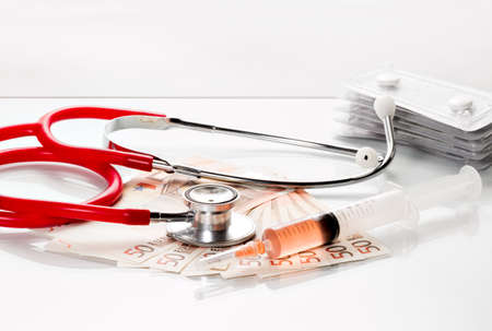 Stethoscope and syringe are on 50 euro notesの写真素材