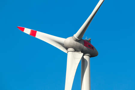 Wind turbine in front of blue cloudy skyの写真素材