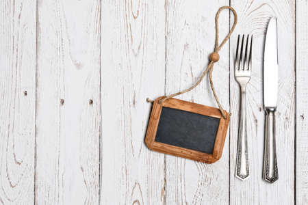 Cutlery is in a napkin wrapped on an old tableの写真素材