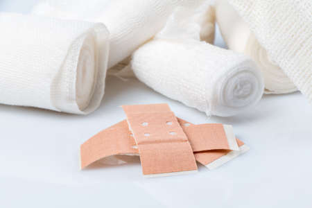 Plasters and bandages with Scissors and syringe on a white backgroundの写真素材