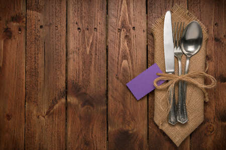Cutlery is in a napkin wrapped on an old table