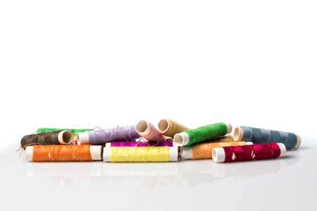 Differently colored rolls sewing thread, on white