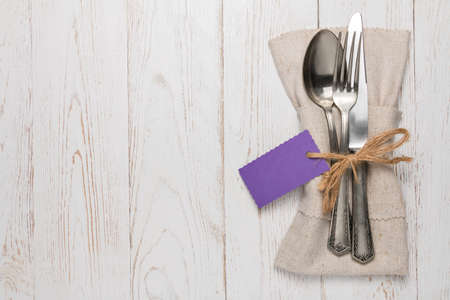 Cutlery is in a napkin wrapped on an old tableの写真素材