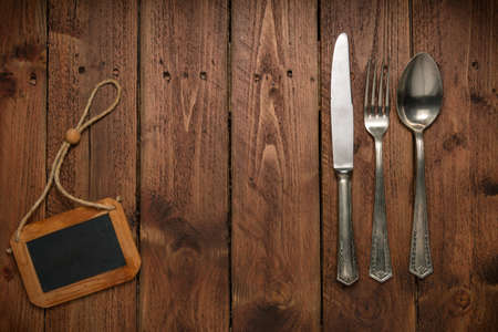 Cutlery is in a napkin wrapped on an old tableの写真素材