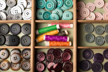 many collected colorful buttons in a box