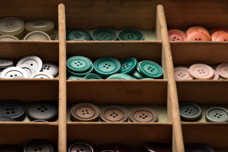 many collected colorful buttons in a boxの写真素材