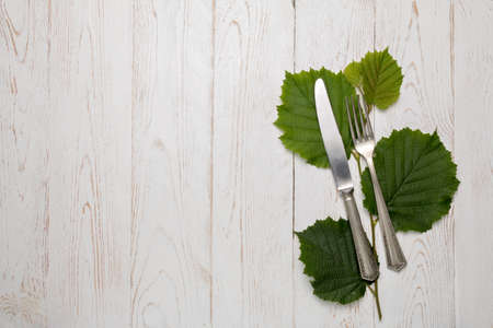 Cutlery is in a napkin wrapped on an old tableの写真素材