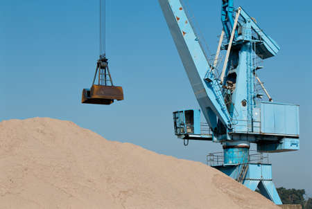 Sand and blue crane in the port channelの写真素材