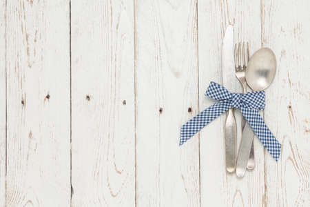 Cutlery is in a napkin wrapped on an old tableの写真素材