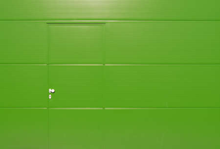 Green hall door with green door and silver colored door handleの写真素材