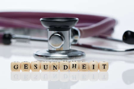Health, word written with cubes, and stethoscopeの写真素材