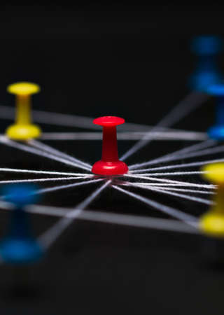 Pin needles connected with black thread, symbolic as a networkの写真素材