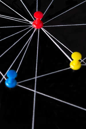 Pin needles connected with black thread, symbolic as a networkの写真素材