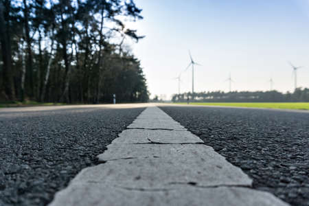 Road leads to windmills in a bioenergy parkの写真素材
