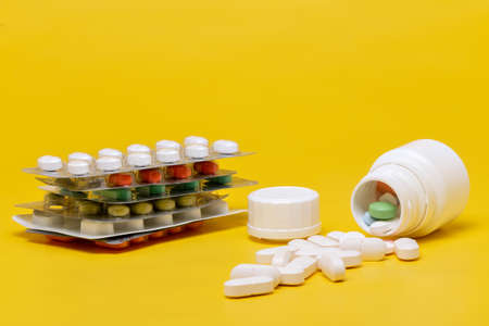 Blister of tablets isolated on a yellow backgroundの写真素材