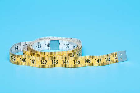 Yellow white tailor tape measure to take measurements and measure