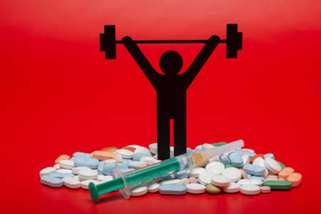 weight lifting pictogram with pills and red backgroundの写真素材