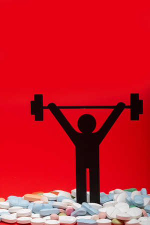 weight lifting pictogram with pills and red backgroundの写真素材