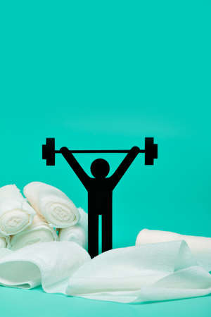 Weight lifting pictogram, Plasters and bandages with Scissors and syringe on a white backgroundの写真素材
