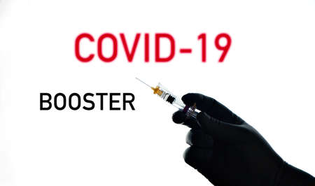 Hand holds syringe for vaccination, with text modulesの写真素材