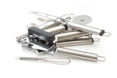 Messy set of silverware against a white background