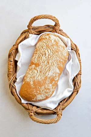 Rustic bread in the bakery basket with napkinの写真素材