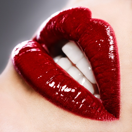 Beautiful female with red shiny lips close upの写真素材