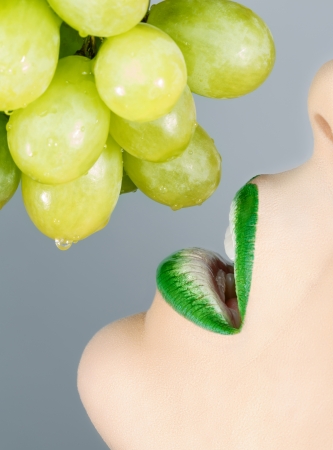 Beautiful lips and grapes の写真素材