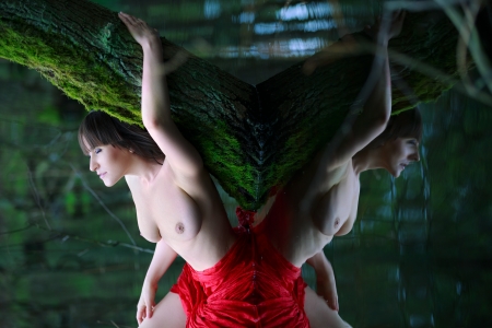 Beautiful woman topless and water reflectionの写真素材