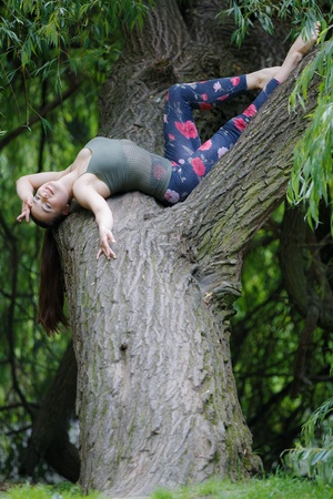 Beautiful woman having a rest on a treeの写真素材