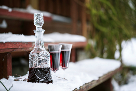 Decanter and wineglasses of red wine outdoors の写真素材